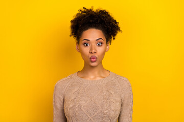 Photo of flirty young brunette lady blow kiss wear beige sweater isolated on yellow color background