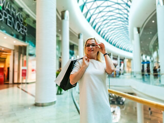 Fototapeta premium Positive emotions. Lifestyle concept. Close up of young charming caucasian woman in white dress smiling
