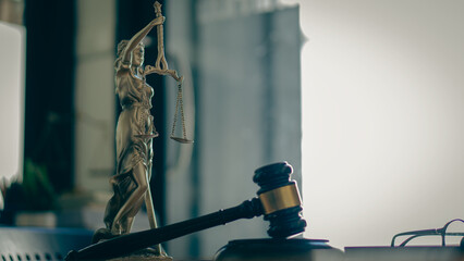 Legal justice concept, goddess scales, and judge's hammer on a wooden table, dealing with court...