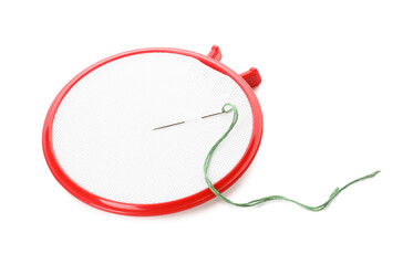 Embroidery hoop with fabric and needle on white background