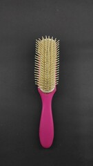 White and pink straight comb isolated on black background, Not Focus