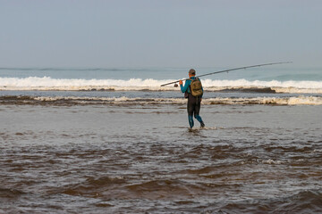 Fototapeta na wymiar Fisherman on Contis Beach. Landes