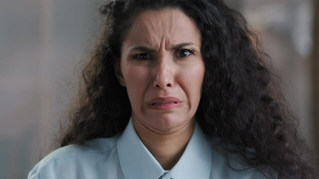 Dissatisfied young confused business woman female employee arabian girl feeling aversion make frowning face squinting wrinkle nose demonstrate discontent grimacing look at disgusting unpleasant thing