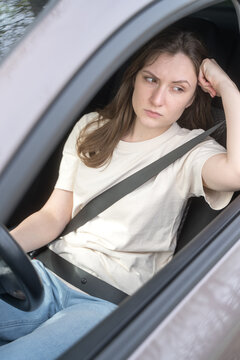 Anxiety and stress. Woman driver behind the wheel of the car is upset. Crisis and depression in life