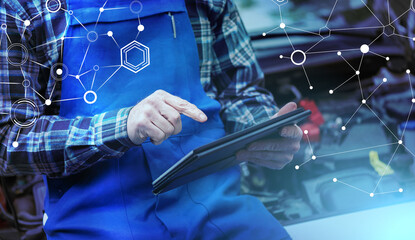 Mechanic using digital tablet for checking car engine; light effect
