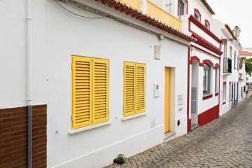 Row of refurbished two story townhouses with yellow-red-gray decoration. Lagos-Portugal-213