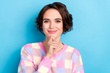 Photo of young lovely woman hand touch chin dreamy thoughtful plaid sweater isolated over blue color background