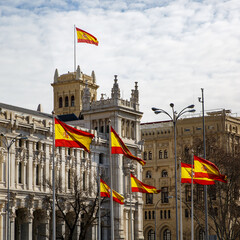 Obraz premium A lot of Spanish flags on buildings background.