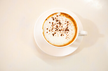 Cappuccino coffee on white table, photo taken in studio. Soft focus