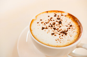 Cappuccino coffee on white table, photo taken in studio. Soft focus