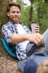 man sitting drinking tea or coffee