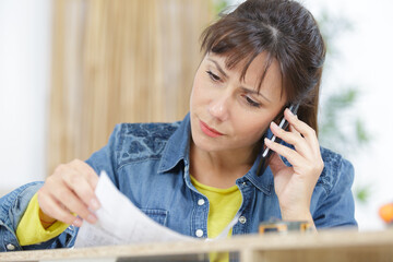 a female on the phone while holding papers
