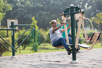 Indian senior man doing exercise at public park