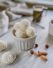 White coconut candies with almond in a bowl, flat lay food 