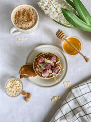 pancakes with raspberry, almond flakes and a cup of coffee , flat lay food