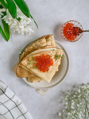 pancakes with red caviar on the plate, flatlay food