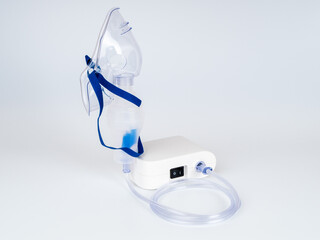 Medical equipment for inhalation with respiratory mask, nebulizer on a white background. Respiratory medicine. Asthma breathing treatment. Bronchitis, asthmatic health equipment