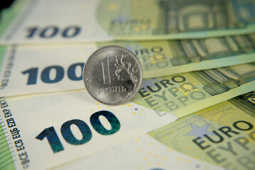one hundred euro banknotes of the European Union and one Russian ruble macro photo