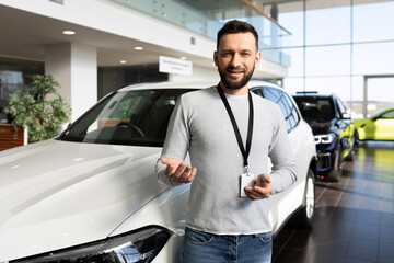 Fototapeta premium manager in a car dealership offers a buyer to buy a new car