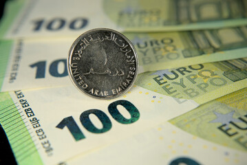 one hundred euro banknotes of the European Union and one dirham united arab emirates macro photo
