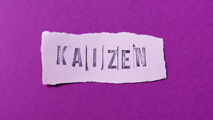 Kaizen word on torn paper edge. Pink background. Japanese word for change for better. Concept of continuous improvement strategy.