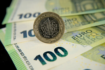 one hundred euro banknotes of the European Union and one Turkish lira macro photo