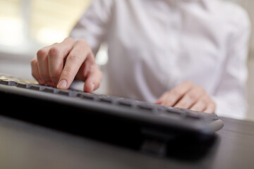  Female hands or woman office worker typing on the keyboard