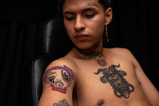 Peruvian shirtless man with tattoos on body