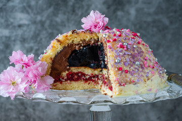 Dome cake - filled with fruity jelly, dark chocolate mousse and raspberry puree, covered with white...