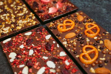 Handmade chocolate bars with a variety of dried fruit and nut toppings.