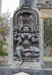 A Beautiful piece of stone sculpture carved out of black sand stone depicting Goddess Padmavati outside a Jain temple in Kanakagiri hills, India.