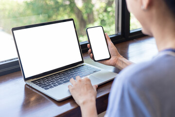 computer screen,cell phone blank mockup.hand woman work using laptop texting mobile.white background for advertising,contact business search information on desk in cafe.marketing,design