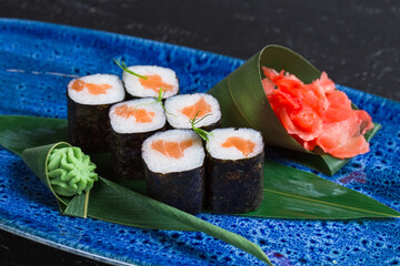 Fresh sushi dish on a blue plate.