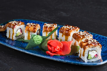 Fresh sushi dish on a blue plate.