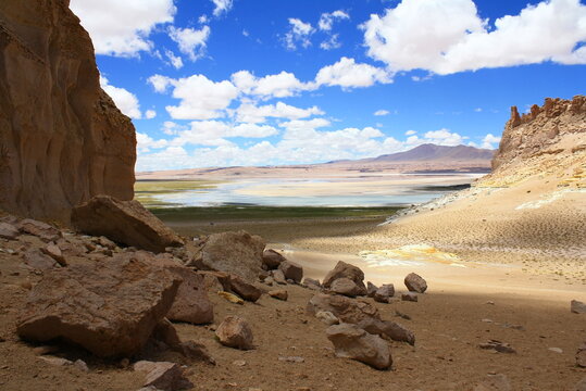 The landscape of the Atacama Desert in Chile, with clouds, volcano, lsand and salt.
