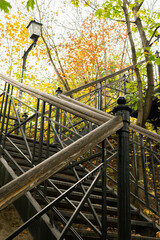 Kyiv (Kiev), Ukraine - October 23, 2020: Metal stairs, steps in vintage ancient style in autumn with many multicolored leaves
