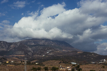 View of a beautiful mountain and sky with space for text, small houses
