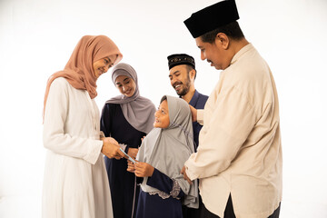 beautiful asian muslim family shake hand on idul fitri celebration