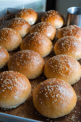 hamburger bun top view, brioce bun with sesame seed freshly baked from the oven