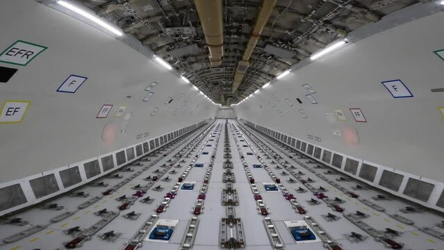 Cargo Airplane - walk inside the main deck cargo compartment on a freshly converted wide-body freighter aircraft, all windows  are removed and the loading system installed