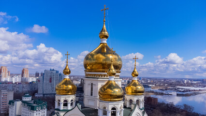 White stone temple with golden domes. Early spring. Russia. The Far East. Khabarovsk. 