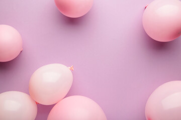 Birthday background with pink balloons on pink background, top view