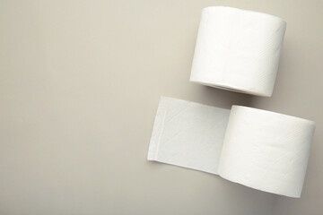 Roll of toilet paper on grey background. Space for text