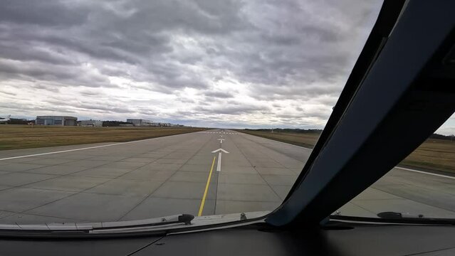 Cockpit view of aTakeoff run in a modern wide-body passenger, cargo aircraft ,  runway 22 at Dresden Airport, Germany, Captains View from brakes release until after liftoff on a windy and cloudy day