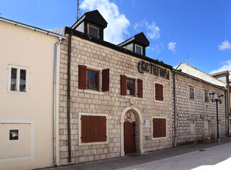 Fototapeta na wymiar Old small stone houses along main street of Cetinje, Montenegro 