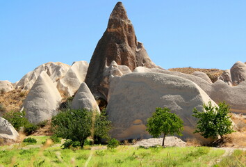 Landscape with a pyramid-shaped mountain and white mountains in the foreground in the Rose Valley between the towns of Goreme and Cavusin in Cappadocia, Turkey