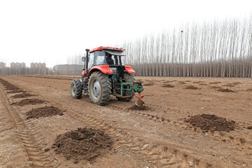 Farmers use machines to drill tree holes for afforestation activities during the Spring Festival in...