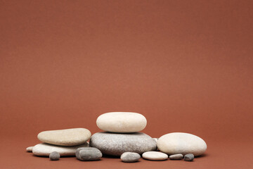 Fototapeta na wymiar stone podium, many pebbles on brown background