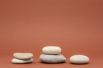 Fototapeta na wymiar stone podium, pebbles on brown background