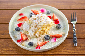 meringue roll with strawberries, blueberries, raspberries and cranberries. Dessert decorated with fresh berries